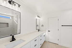 Bathroom with double vanity and baseboards