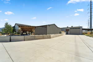View of front of home with a garage, driveway, and a carport