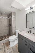 Full bath featuring vanity, a shower stall, and light wood finished floors