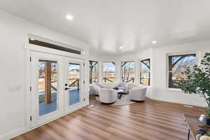 Living area featuring french doors, recessed lighting, and light wood finished floors