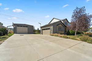 View of property exterior featuring board and batten siding and a detached garage