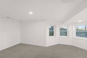 Spare room with recessed lighting, carpet, and plenty of natural light