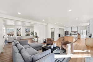 Living room with recessed lighting and light wood-type flooring