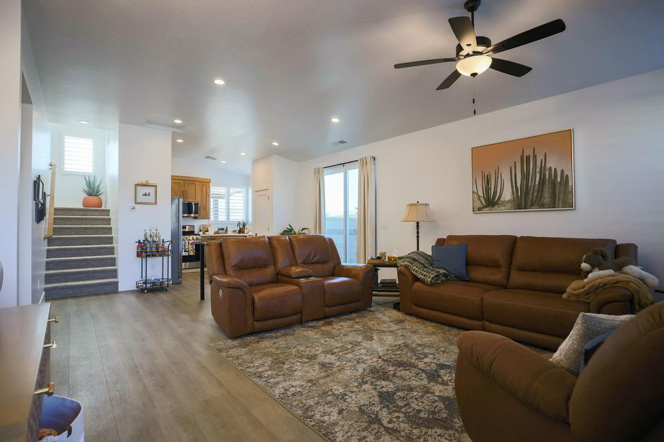 Living room featuring stairway, wood finished floors, recessed lighting, and ceiling fan