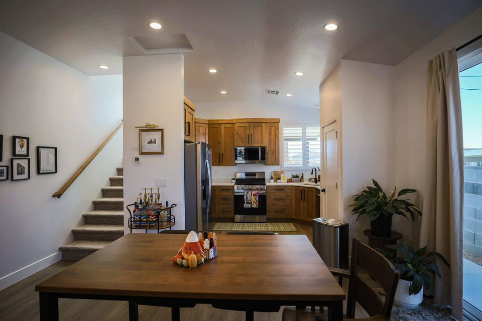 Kitchen featuring brown cabinets, appliances with stainless steel finishes, light countertops, and recessed lighting