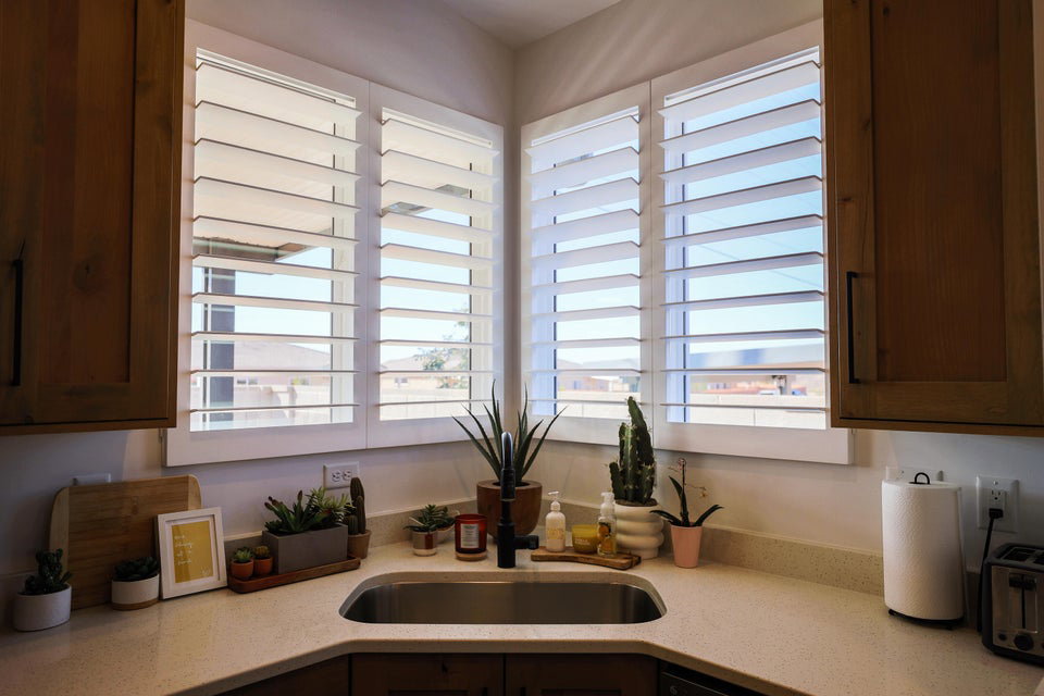 Kitchen with light stone countertops and plenty of natural light