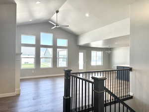 Hall featuring dark wood-style floors, a chandelier, an upstairs landing, recessed lighting, and high vaulted ceiling