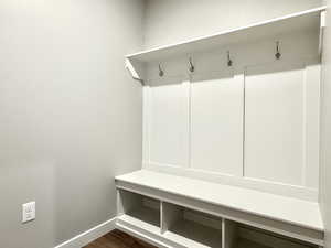 Mudroom with baseboards and dark wood finished floors