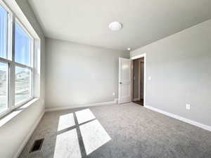 Unfurnished room featuring carpet flooring and baseboards