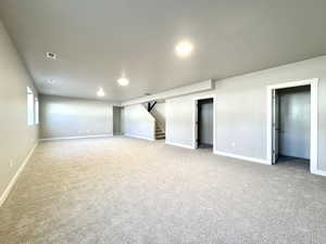 Below grade area with stairway and light carpet