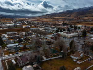 Aerial overview of property's location featuring nearby suburban area and a mountain backdrop