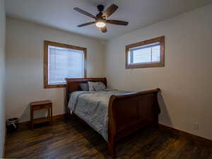 Bedroom featuring dark wood-type flooring and ceiling fan