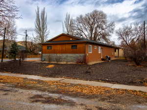 View of side of home with stone siding
