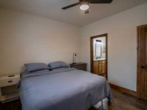 Primary Bedroom featuring dark wood-type flooring, a ceiling fan, and ensuite bath