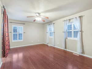 Spare room with wood finished floors and a ceiling fan