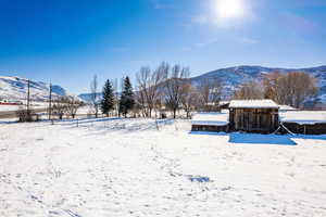 Snowy yard featuring a mountain view