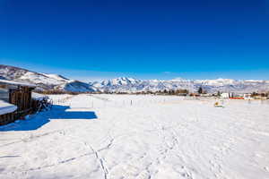 Snowy yard featuring a mountain view