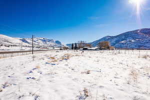 Yard covered in snow with a mountain view