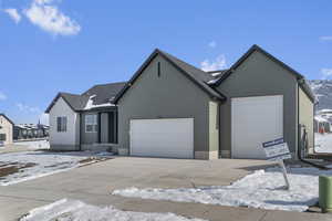 Ranch-style home with a garage and driveway