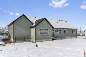 Snow covered property featuring stucco siding