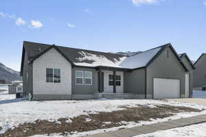 View of front of property with a garage, brick siding, and a mountain view