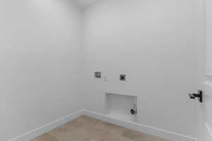 Laundry room with hookup for an electric dryer and hookup for a washing machine