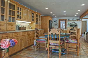 Dining room with recessed lighting, a textured ceiling, and light tile patterned flooring