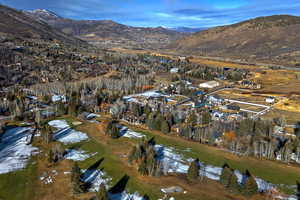 Aerial view of property's location featuring a mountainous background