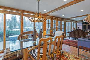 Dining room with healthy amount of natural light, a chandelier, and recessed lighting
