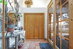 Washroom featuring light tile patterned floors and french doors