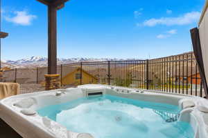 View of swimming pool featuring a hot tub and a mountain view