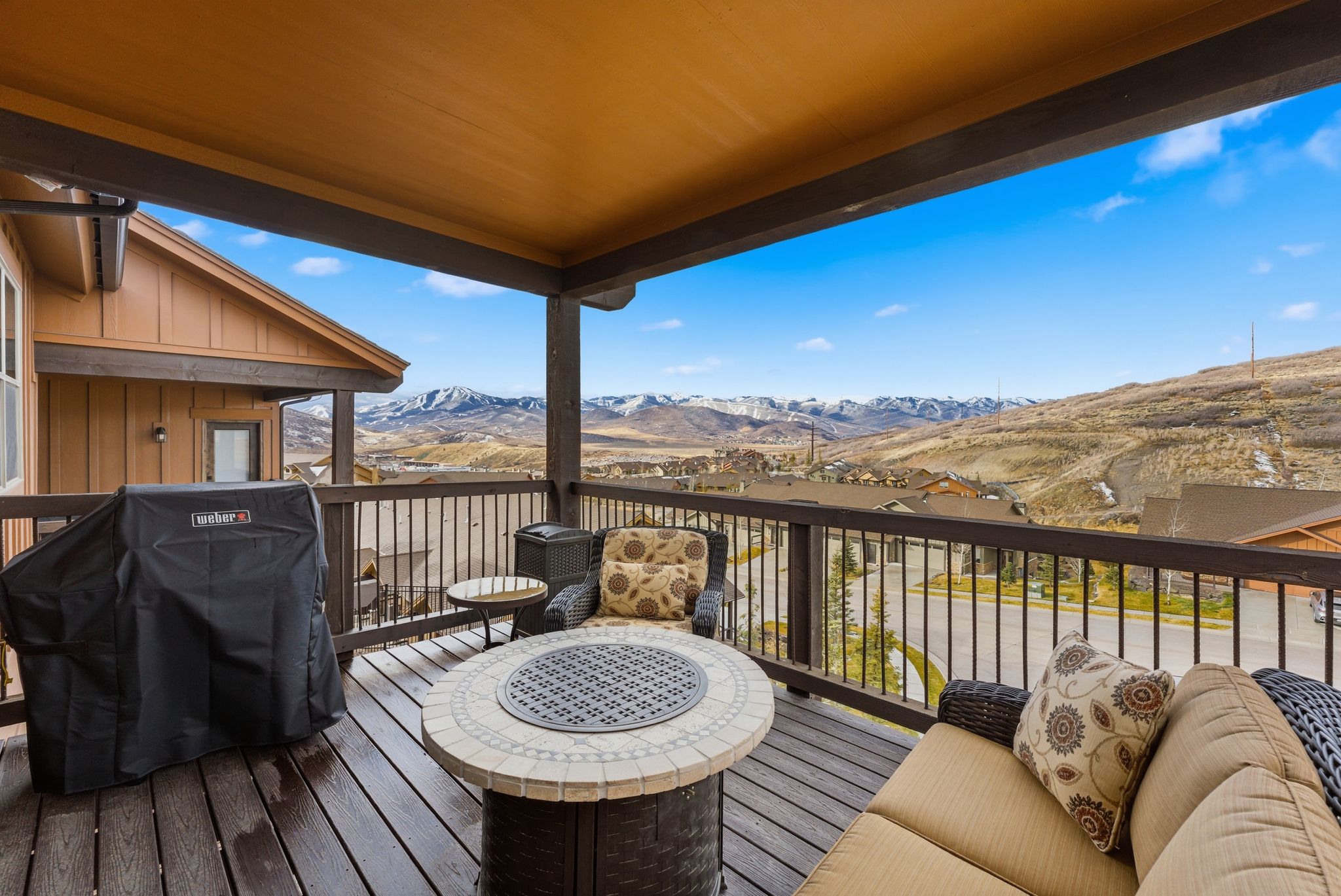Wooden terrace with a grill and a mountain view