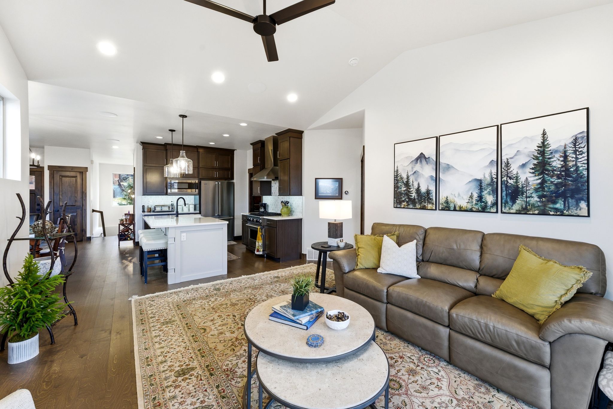 Living area with ceiling fan, dark wood finished floors, recessed lighting, and lofted ceiling