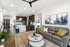 Living area with ceiling fan, dark wood finished floors, recessed lighting, and lofted ceiling