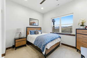 Bedroom featuring light colored carpet, ceiling fan, and recessed lighting