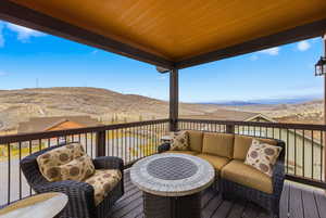 Wooden terrace featuring an outdoor hangout area and a mountain view