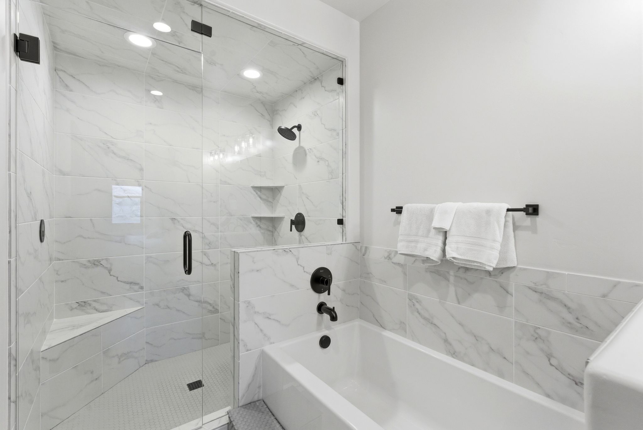 Full bath with a garden tub and a marble finish shower
