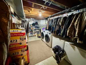 Unfinished below grade area with white fridge and washer and dryer