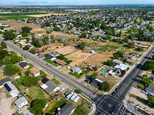 Aerial view of property and surrounding area with nearby suburban area