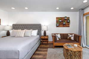 Bedroom with wood finished floors and recessed lighting