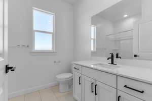 Bathroom with vanity, recessed lighting, and a shower
