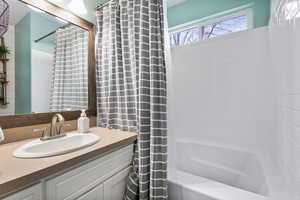 Bathroom featuring shower / bath combo and vanity
