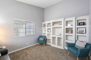Living area with carpet floors and baseboards