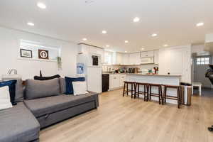 Living area featuring recessed lighting and light wood-type flooring