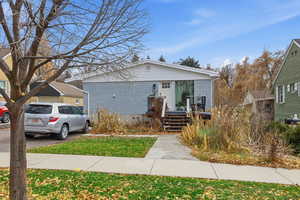 View of front of house with brick siding and a front yard