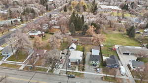 Aerial view of property and surrounding area featuring nearby suburban area