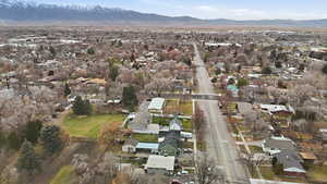 Aerial view of property's location with nearby suburban area and a mountainous background