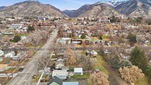 Aerial overview of property's location featuring mountains and nearby suburban area