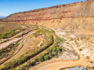 Aerial view of sparsely populated area featuring a mountain backdrop and a desert landscape