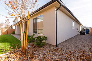 View of home's exterior with stucco siding and a patio